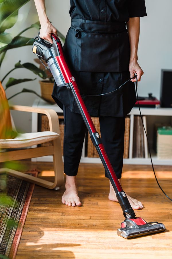A red stick vacuum in a living room