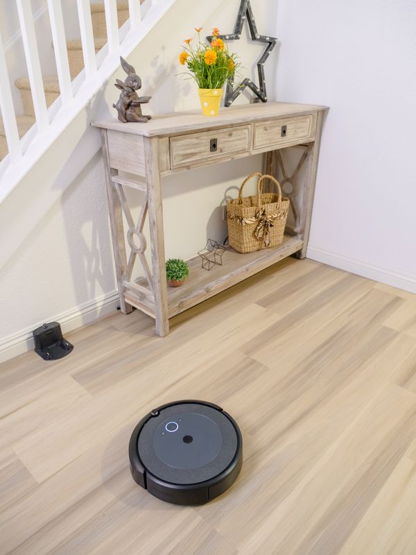 A robot vacuum on a wooden floor